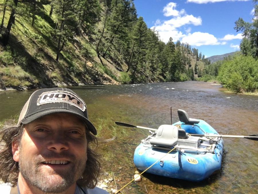 Rob Smith beside his raft on a mountain river