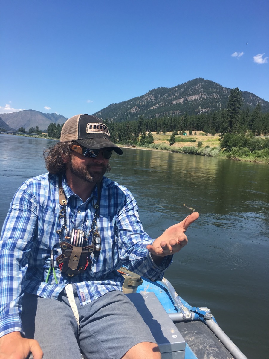 Rob Smith fly-fishing from a drift boat on the river
