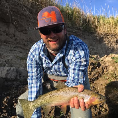 Rob Smith with a freshly caught trout on the riverbank