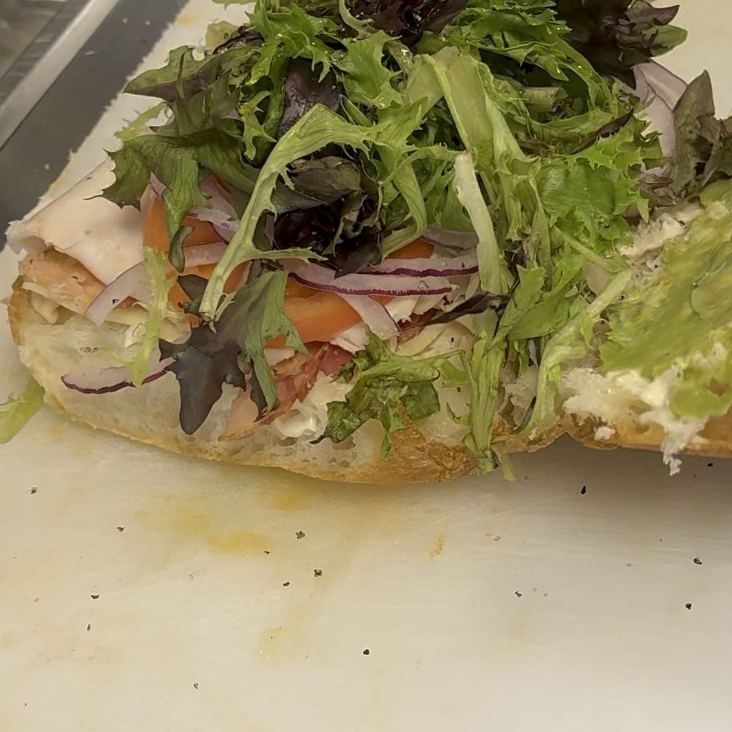 The Beach Boy at Tagliare Delicatessen in Airway Heights — turkey, bacon, swiss, red onion, tomato and greens, with avocado spread on the top half of the roll